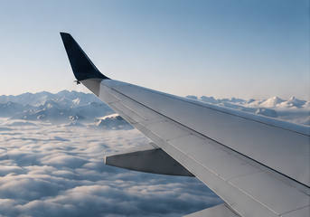 View over an aircraft wing above clouds on an international flight